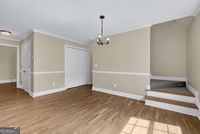 interior space with baseboards, wood finished floors, and a chandelier