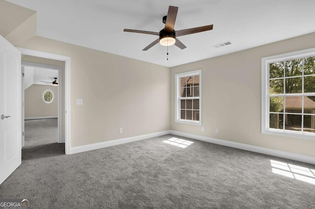 unfurnished bedroom with carpet floors, baseboards, a ceiling fan, and visible vents