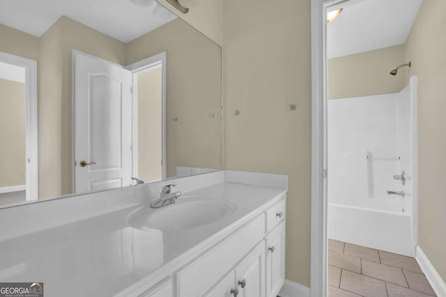 bathroom with shower / bath combination, baseboards, tile patterned flooring, and vanity