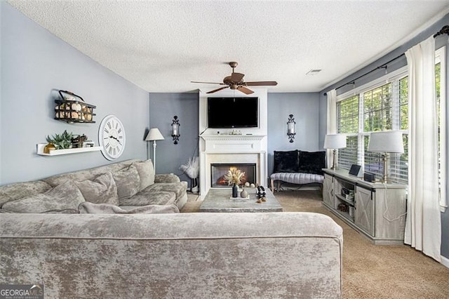 10 Callaway Ct, Hiram, GA 30141 - living area with carpet flooring, a textured ceiling, a lit fireplace, and a ceiling fan