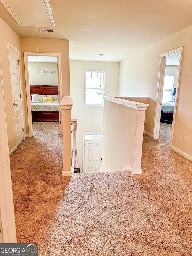 573 Emporia Loop, Mcdonough, GA 30253 - hallway with visible vents, attic access, an upstairs landing, and carpet flooring