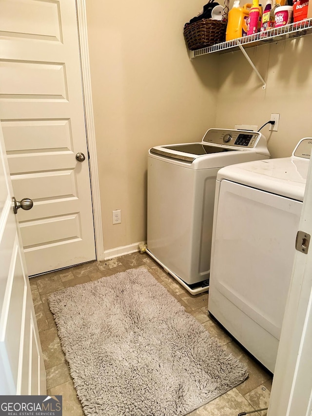 573 Emporia Loop, Mcdonough, GA 30253 - laundry room with baseboards, laundry area, and washer and clothes dryer