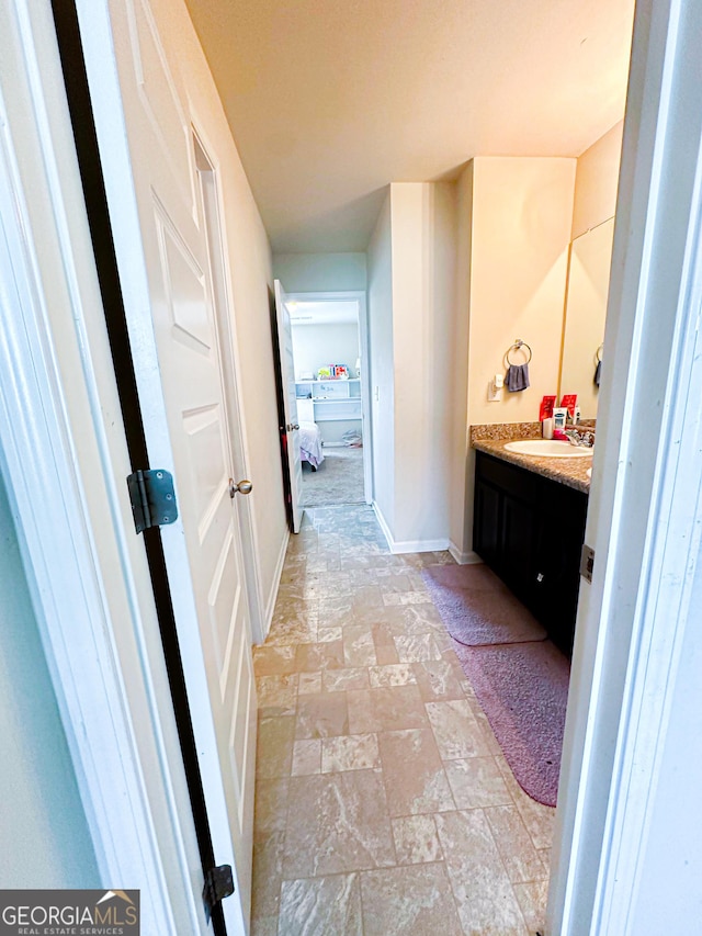 573 Emporia Loop, Mcdonough, GA 30253 - bathroom featuring baseboards, stone finish floor, and vanity