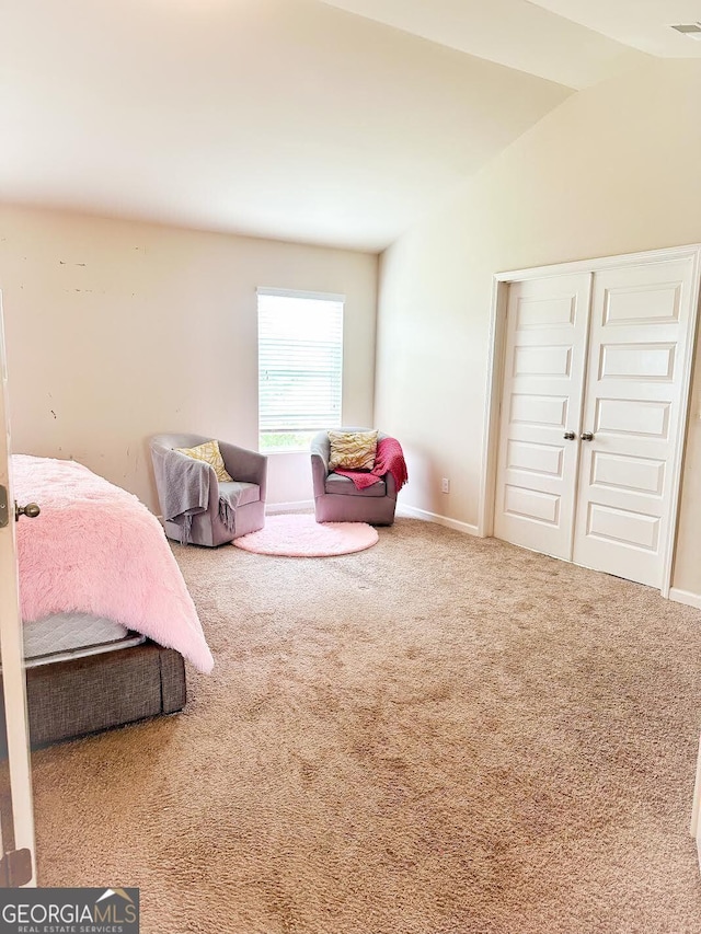 573 Emporia Loop, Mcdonough, GA 30253 - carpeted bedroom featuring a closet, vaulted ceiling, and baseboards