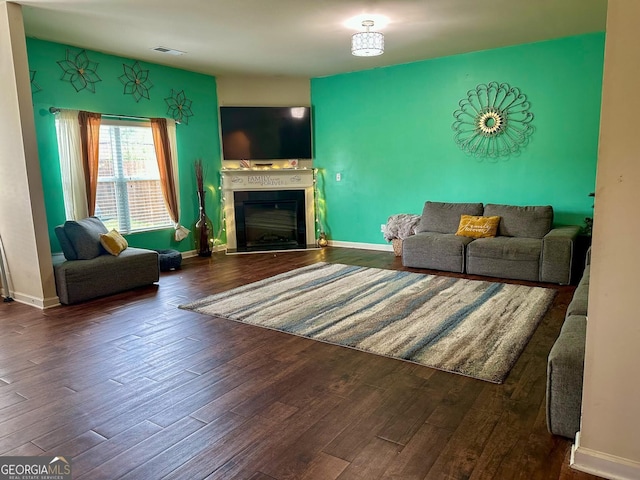 573 Emporia Loop, Mcdonough, GA 30253 - living room featuring a fireplace, wood finished floors, and baseboards