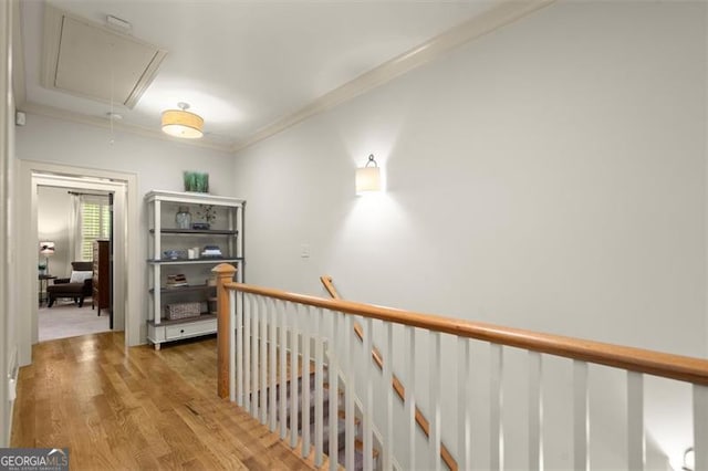 719 Hammond Dr, Woodstock, GA 30188 - hallway with attic access, light wood-style flooring, crown molding, and an upstairs landing