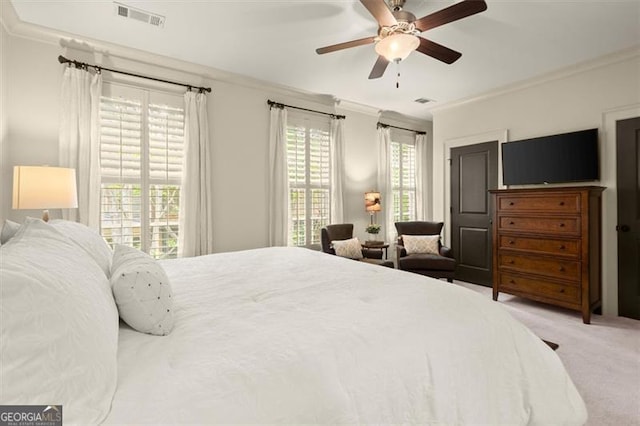 carpeted bedroom featuring visible vents, ornamental molding, and ceiling fan