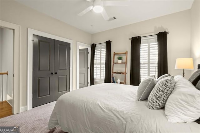 719 Hammond Dr, Woodstock, GA 30188 - bedroom featuring multiple windows, a closet, carpet, and ceiling fan