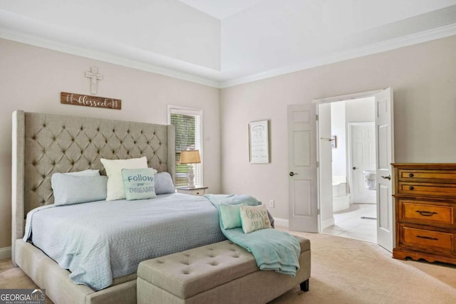 bedroom with crown molding, baseboards, light carpet, and ensuite bath