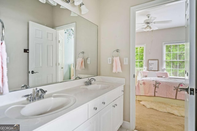 ensuite bathroom featuring double vanity, ceiling fan, a sink, and ensuite bathroom