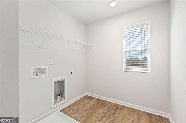 laundry area featuring washer hookup, laundry area, electric dryer hookup, baseboards, and wood finished floors