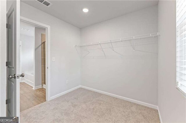 walk in closet with carpet flooring and visible vents