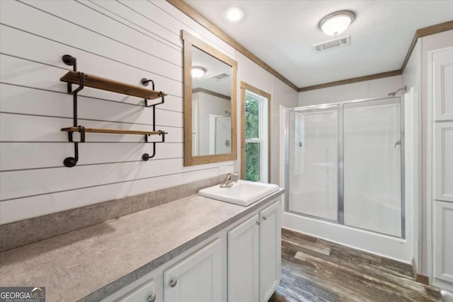 1293 Lake Dr, Midway, GA 31320 - full bath with crown molding, a shower stall, wood finished floors, and visible vents