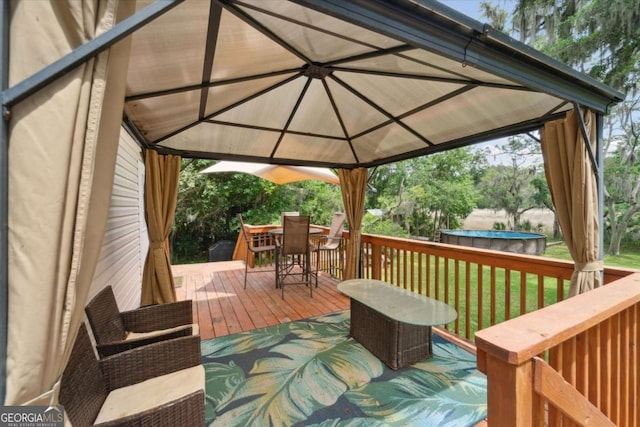 1293 Lake Dr, Midway, GA 31320 - deck featuring a gazebo, a lawn, and outdoor dining space