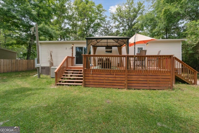 1293 Lake Dr, Midway, GA 31320 - rear view of property with a gazebo, a yard, fence, and stairs