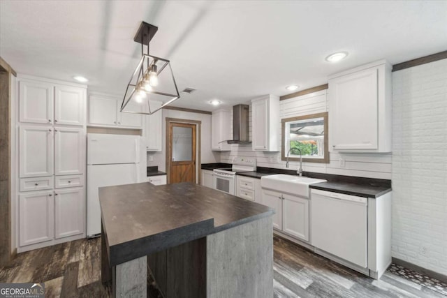 1293 Lake Dr, Midway, GA 31320 - kitchen featuring wall chimney range hood, brick wall, dark wood finished floors, a sink, and white appliances