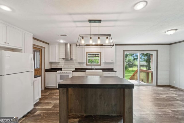 1293 Lake Dr, Midway, GA 31320 - kitchen with a sink, dark countertops, wall chimney exhaust hood, and white appliances