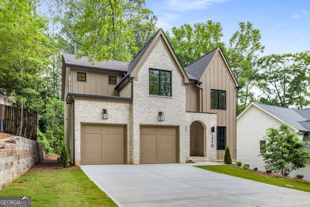 view of front of house with board and batten siding, brick siding, a shingled roof, concrete driveway, and an attached garage