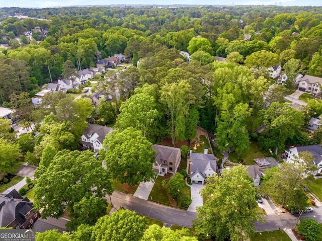 bird's eye view featuring a residential view and a wooded view
