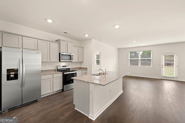 1400 Adirondac Way, Bonaire, GA 31005 - kitchen with light stone counters, stainless steel appliances, a sink, baseboards, and dark wood-type flooring