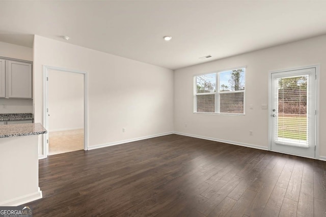 1400 Adirondac Way, Bonaire, GA 31005 - unfurnished living room featuring dark wood-style floors and baseboards