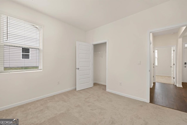1400 Adirondac Way, Bonaire, GA 31005 - unfurnished bedroom featuring baseboards, a closet, multiple windows, and carpet flooring