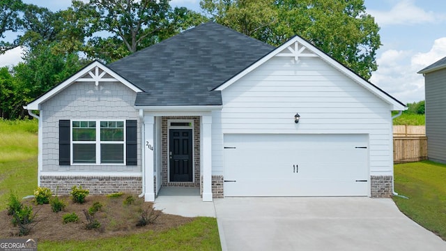 1400 Adirondac Way, Bonaire, GA 31005 - view of front facade featuring a garage, a shingled roof, driveway, brick siding, and fence