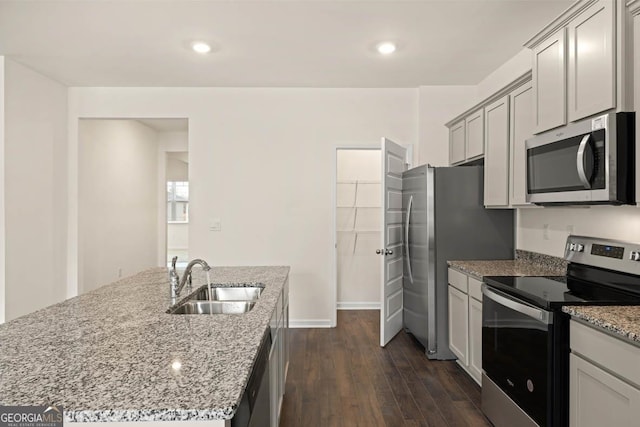 1400 Adirondac Way, Bonaire, GA 31005 - kitchen featuring dark wood-style floors, light stone countertops, a sink, stainless steel appliances, and a center island with sink