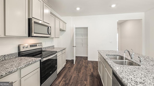 1400 Adirondac Way, Bonaire, GA 31005 - kitchen featuring light stone countertops, stainless steel appliances, dark wood-style flooring, a sink, and baseboards