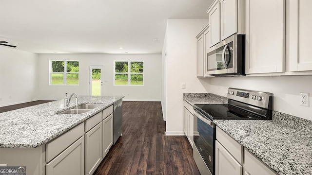 1400 Adirondac Way, Bonaire, GA 31005 - kitchen with light stone countertops, a sink, appliances with stainless steel finishes, and dark wood-type flooring
