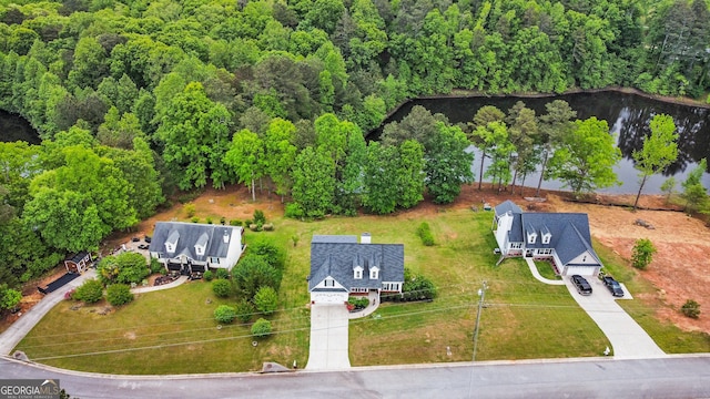 birds eye view of property with a water view and a forest view