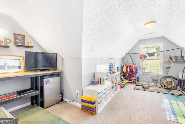 recreation room featuring lofted ceiling, a textured ceiling, baseboards, and carpet floors