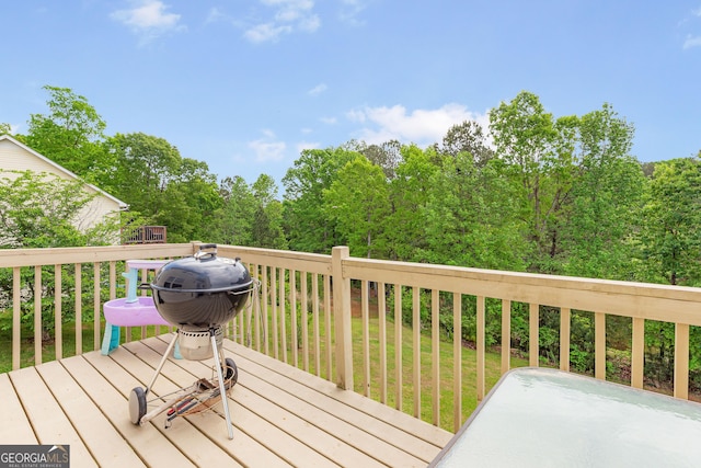 wooden deck featuring a yard