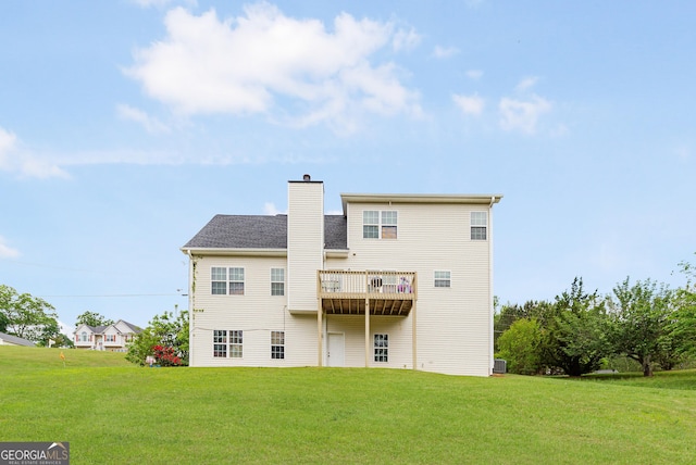 rear view of property with a lawn and a chimney