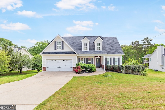 view of front facade with a front yard, a shingled roof, covered porch, driveway, and brick siding