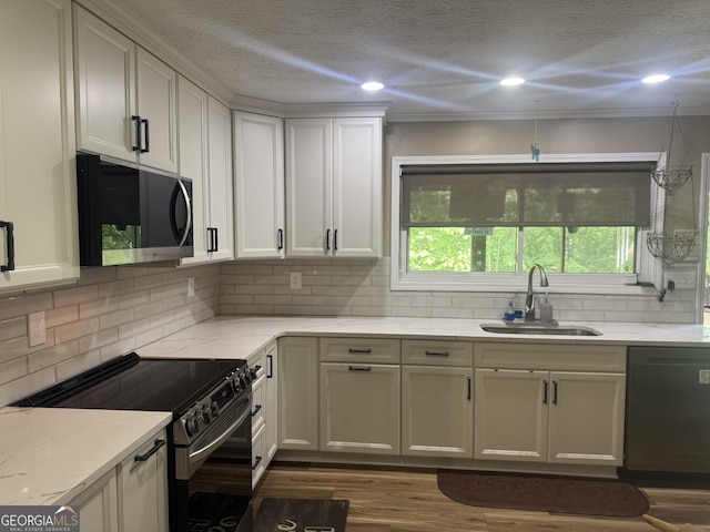 1685 Bailey Creek Rd SW, Conyers, GA 30094 - kitchen with a sink, appliances with stainless steel finishes, tasteful backsplash, and light stone counters
