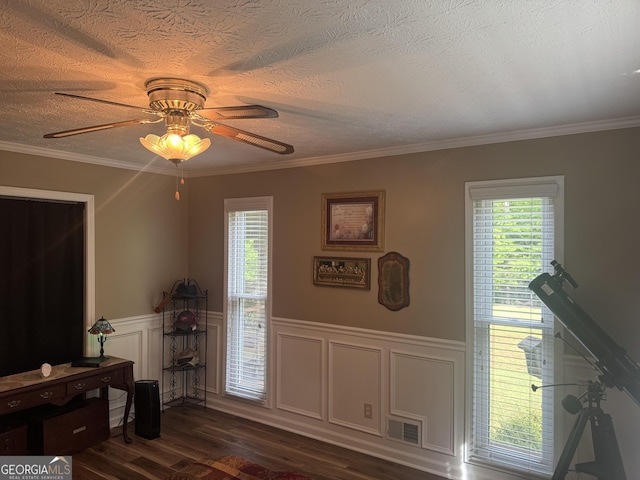 1685 Bailey Creek Rd SW, Conyers, GA 30094 - interior space featuring a healthy amount of sunlight, a ceiling fan, wainscoting, and dark wood-type flooring