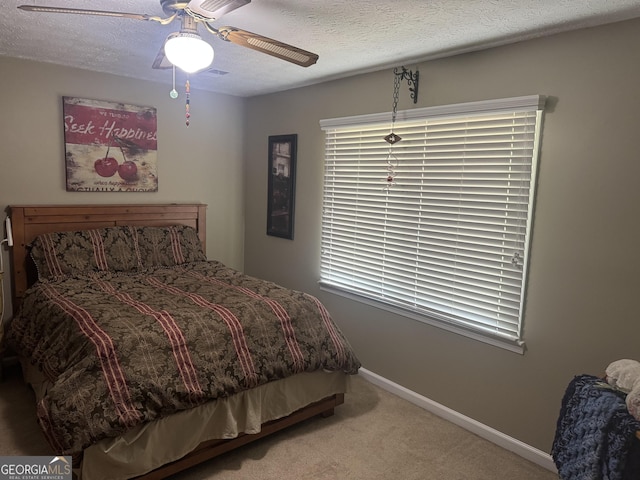 1685 Bailey Creek Rd SW, Conyers, GA 30094 - bedroom with carpet floors, a textured ceiling, baseboards, and a ceiling fan