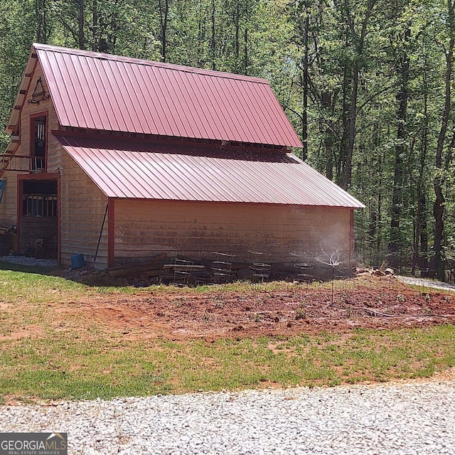 1685 Bailey Creek Rd SW, Conyers, GA 30094 - view of side of home featuring metal roof and a wooded view