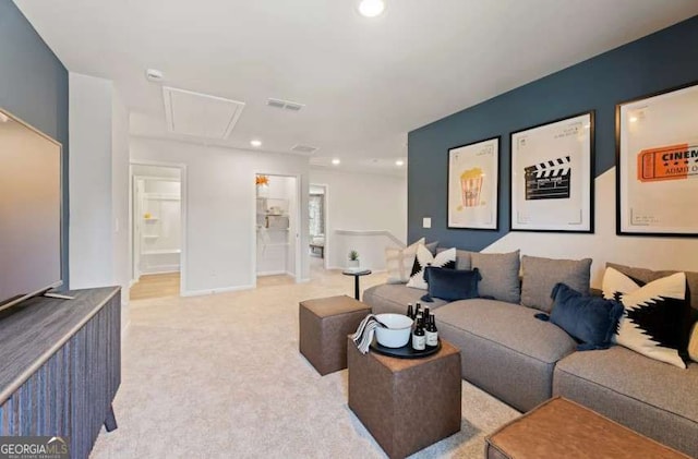 living room with attic access, recessed lighting, visible vents, and light carpet