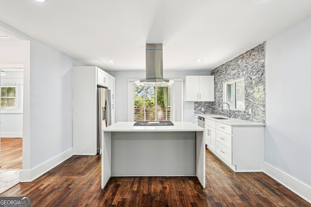 kitchen with island range hood, a center island, light countertops, a sink, and stainless steel appliances