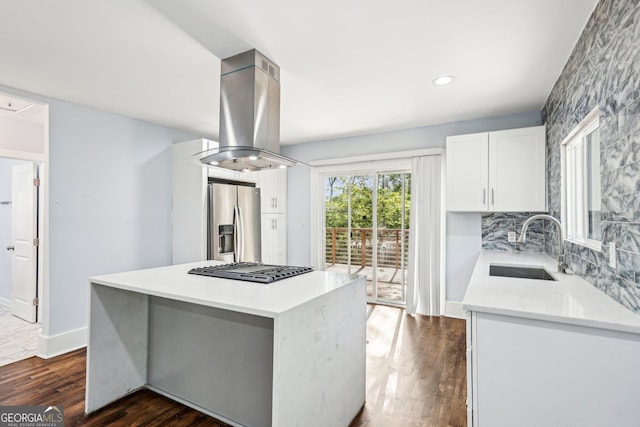 kitchen featuring island range hood, stainless steel refrigerator with ice dispenser, dark wood-type flooring, white cabinetry, and a sink