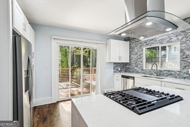 kitchen featuring white cabinets, a sink, light countertops, stainless steel appliances, and island range hood