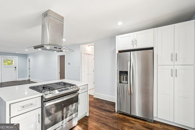 kitchen featuring light countertops, stainless steel appliances, white cabinetry, and island range hood