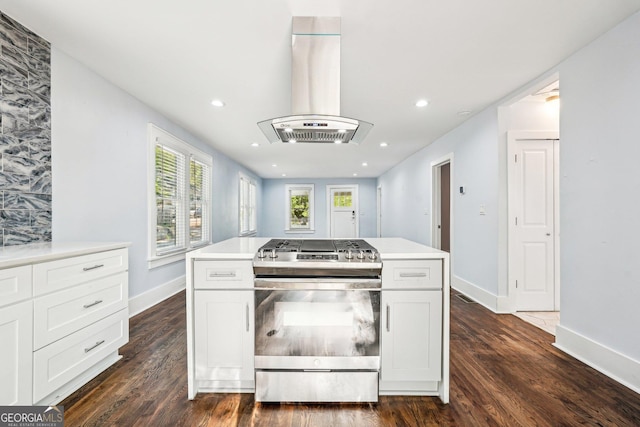 kitchen featuring baseboards, stainless steel gas range, ventilation hood, recessed lighting, and dark wood-type flooring