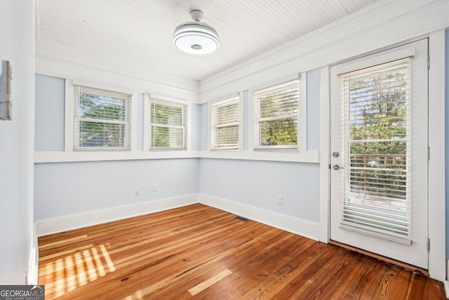unfurnished sunroom featuring visible vents