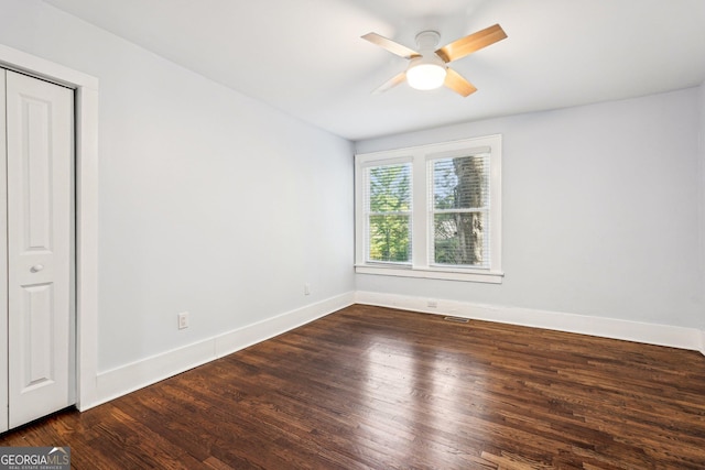 spare room featuring ceiling fan, baseboards, visible vents, and wood finished floors