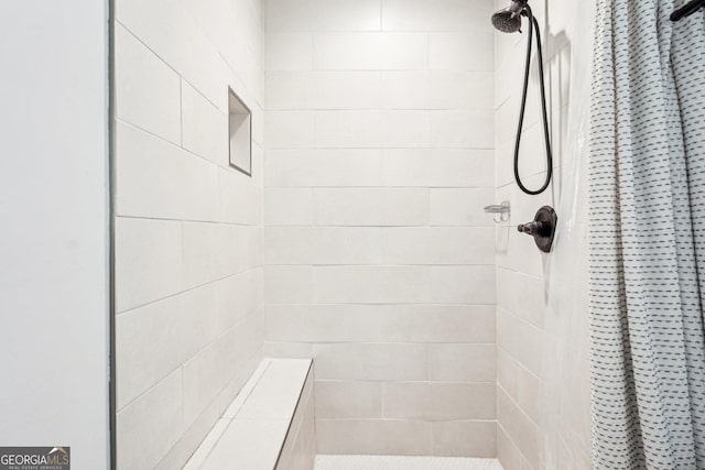 full bath with a tile shower