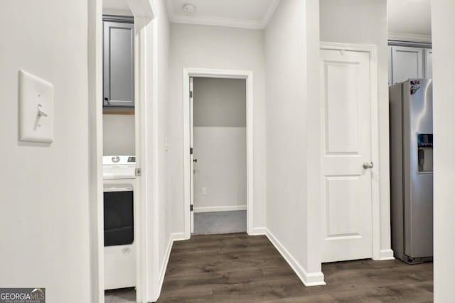 hallway with dark wood finished floors, baseboards, washer / clothes dryer, and crown molding