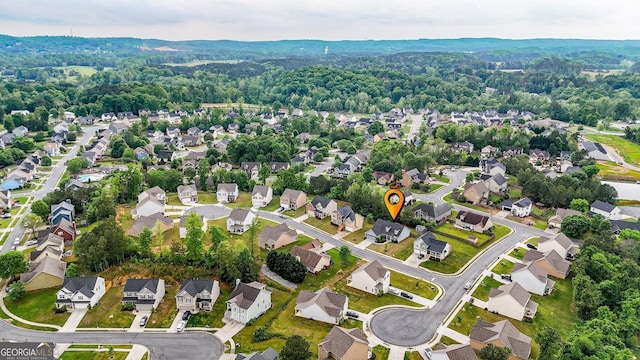 birds eye view of property with a forest view and a residential view